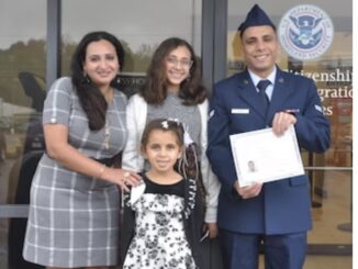 Then Airman 1st Class Yosry Zaki, celebrates with his wife and daughters after taking the Naturalization Oath of Allegiance to the United States of America during a ceremony in Montgomery, Ala., Nov. 15, 2023. Zaki, now a Senior Airman, is a flight services technician in the 908th Aeromedical Evacuation Squadron at Maxwell Air Force Base, Ala. (U.S. Air Force photo by Bradley J. Clark)
