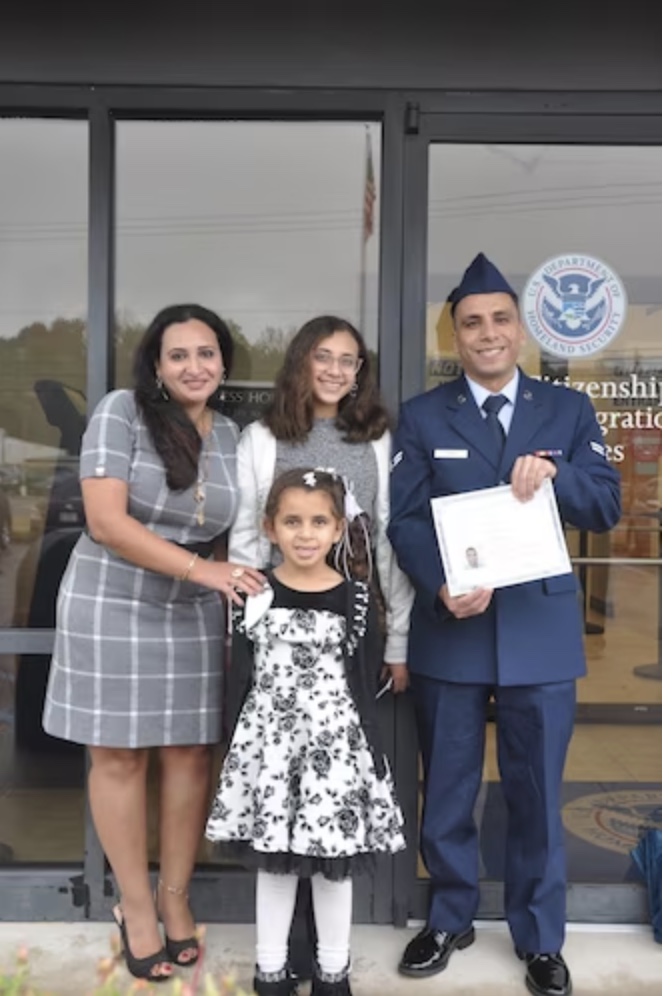 Then Airman 1st Class Yosry Zaki, celebrates with his wife and daughters after taking the Naturalization Oath of Allegiance to the United States of America during a ceremony in Montgomery, Ala., Nov. 15, 2023. Zaki, now a Senior Airman, is a flight services technician in the 908th Aeromedical Evacuation Squadron at Maxwell Air Force Base, Ala. (U.S. Air Force photo by Bradley J. Clark)
